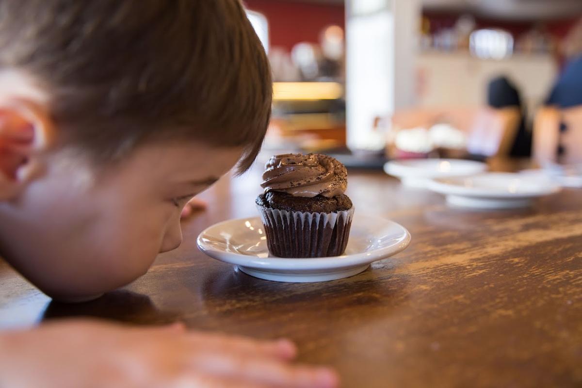 Closeup kid with a cupcake